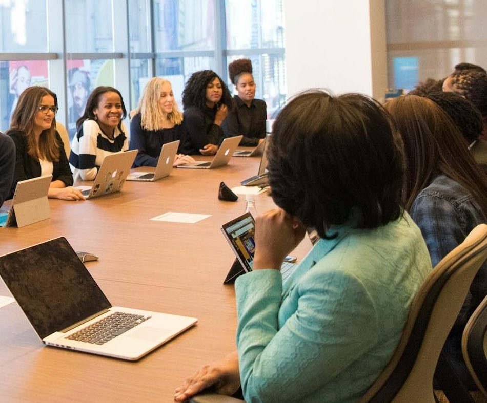 A diverse team of business professionals collaborating in a modern meeting room.